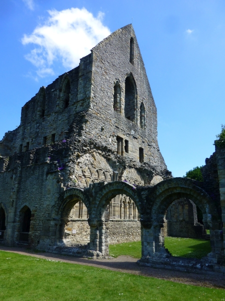 the decorated norman arched doorway between the chapter house and cloister of wenlock priory, shropshire