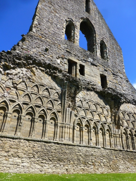 the beautifully carved stone wall within the chapter house of wenlock priory, shropshire