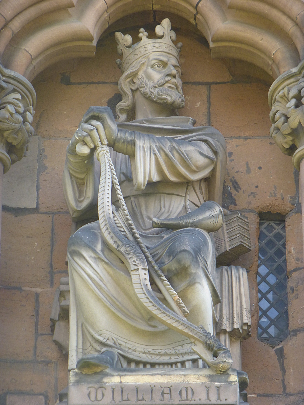 The Figure of King William II Sitting Proudly on the Front of Lichfield Cathedral © essentially-england.com