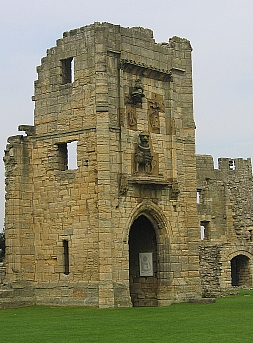 Warkworth Castle tower with Percy Lion © essentially-england.com
